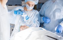 Anesthesiologist assistant concentrates during surgical task. 